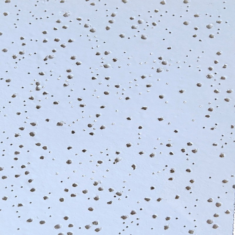 Mineral fiber tile perforated surface